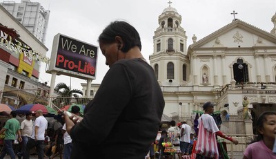 
              A "Pro-Life" sign flashes on an electric signboard outside the Roman Catholic Minor Basilica of the Black Nazarene in downtown Manila, Philippines on Thursday, Jan. 3, 2013. Philippine 